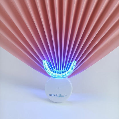 Grin & Glow Teeth Whitening Kit – vegan-friendly, non-invasive whitening system with LED light, whitening gel, and applicator for a brighter smile at home.