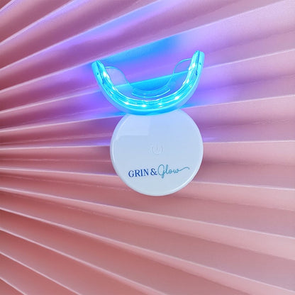 Grin & Glow Teeth Whitening Kit – vegan-friendly, non-invasive whitening system with LED light, whitening gel, and applicator for a brighter smile at home.
