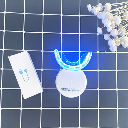 Grin & Glow Teeth Whitening Kit – vegan-friendly, non-invasive whitening system with LED light, whitening gel, and applicator for a brighter smile at home.