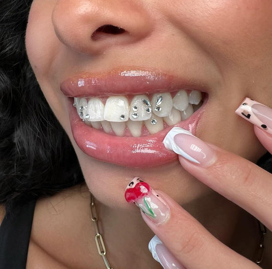 Close-up of tooth gems applied by Grin & Glow, featuring high-quality, non-invasive crystals for a stylish, sparkling smile upgrade